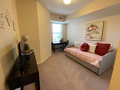 Cozy resident room with a sofa and desk
