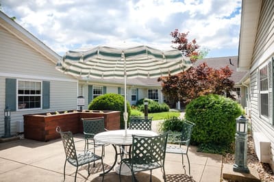 Outdoor seating area with a striped umbrella