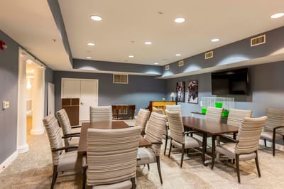 Common area with tables and chairs in a nursing home