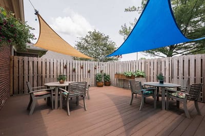 Sunny outdoor patio area with shaded seating