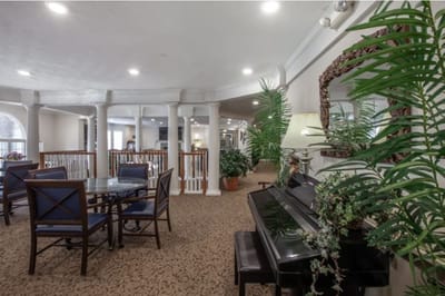 Bright common area with seating and piano