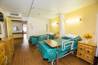 A shared resident room with two beds and decor