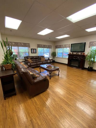 Interior of a common room with seating and plants