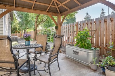 Cozy outdoor seating area with plants and a table