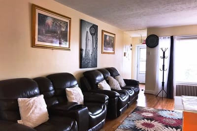 Living room area with leather seating and artwork on the walls