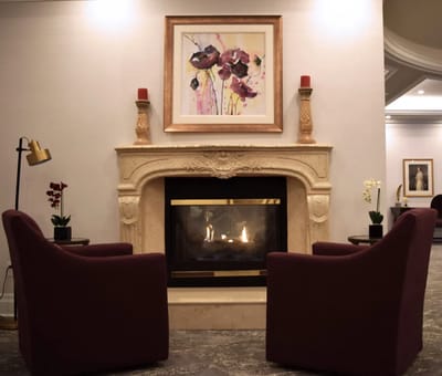 Cozy sitting area with a fireplace and artwork