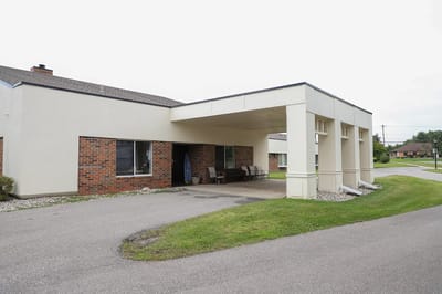 Exterior view of the facility entrance with a covered area