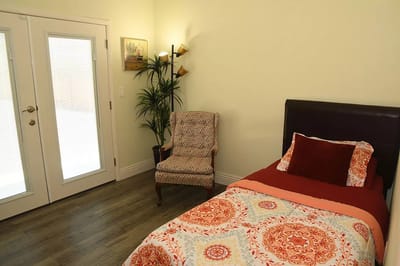 Cozy private room with a bed and chair
