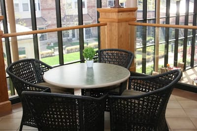 Common area with a table and chairs overlooking the garden