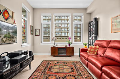 Bright interior living area with red couch and large windows