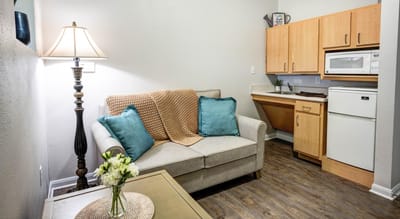 Cozy assisted living room with kitchen area