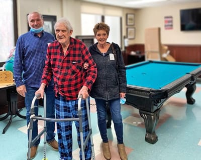 Residents enjoying time in a common area with staff.