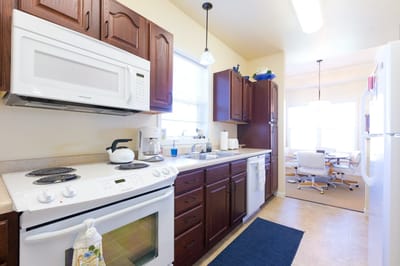 Bright kitchen space with dining area in background