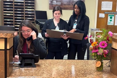 Staff assisting each other at the reception area