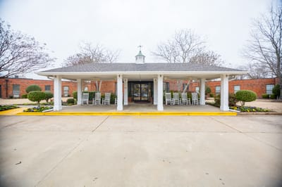 Maplewood Health Care Center, Nursing Home in Jackson, TN — Front entrance of a nursing home facility with rocking chairs