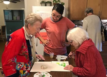 Grace Barker Nursing Center, Nursing Home in Warren, RI — Seniors engaged in a painting activity indoors