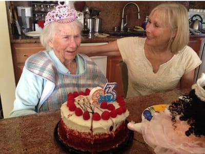 Resident celebrating birthday with family and cake