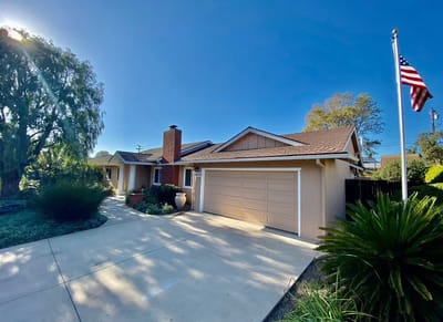 Exterior view of a residential building with landscaping.