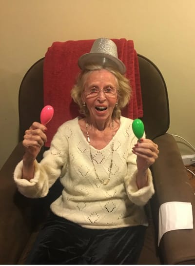 Elderly woman celebrating with maracas