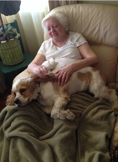Resident with a dog in a cozy setting.