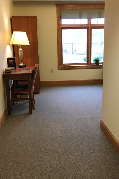 Interior view of a corridor with a lamp and desk
