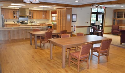 Bright common area with wooden tables and chairs