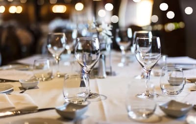 Dining area set with empty glasses and table settings