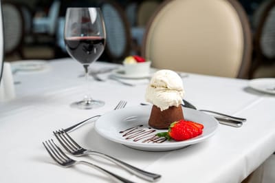 Dessert served in a dining room with wine