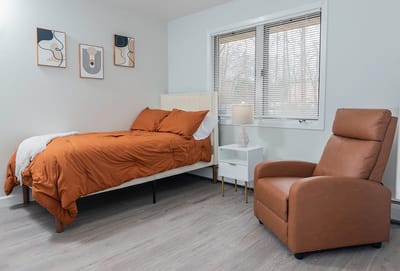Cozy private room with bed and chair