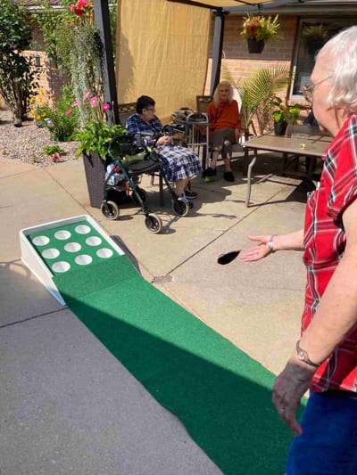 Residents enjoying a game outdoors on a sunny day