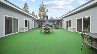 Outdoor courtyard area with seating and greenery