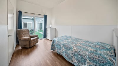 Private resident room with a comfortable chair and bed