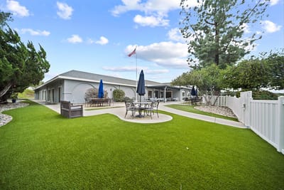 Outdoor patio area with seating and greenery