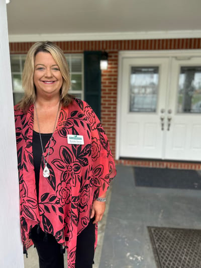 Staff member welcoming at the entrance of the facility