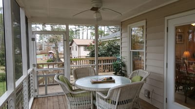 Screened porch with a table and chairs