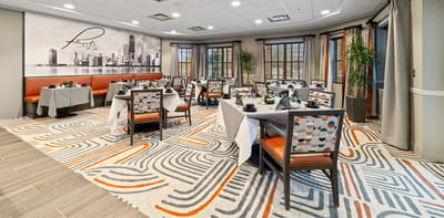 Bright dining room with tables set for meals