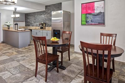 Dining area with tables and kitchen appliances