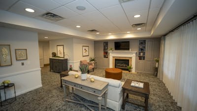 A cozy common area with seating and a fireplace