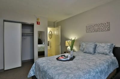 Cozy resident room with a bed and a tray of food