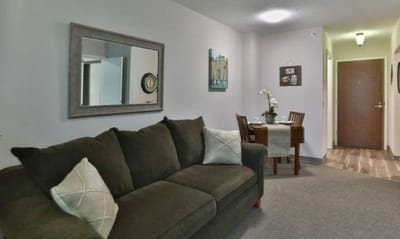 Cozy resident room with a sofa and dining table