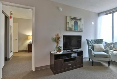 Cozy interior of a resident room with a chair and TV