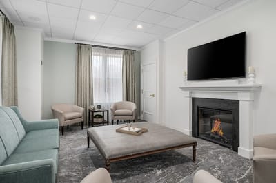Bright common area with comfortable seating and a fireplace