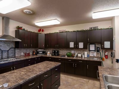 Bright kitchen area with modern appliances and decorations