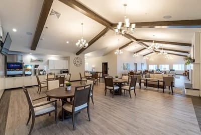 Bright and spacious common area with tables and seating