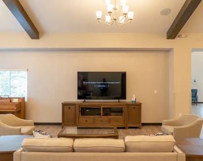 Interior view of a common area with seating and TV