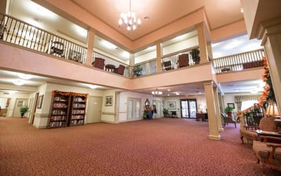 Bright common area with comfortable seating and bookshelves