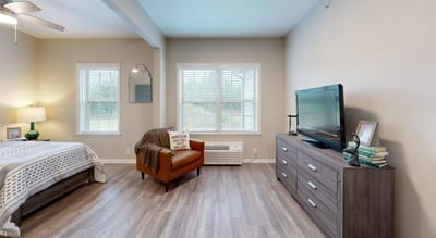 Cozy private resident room with a bed and seating area.