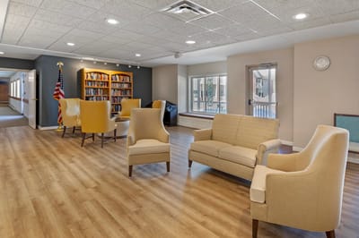 Bright common area with seating and bookshelves