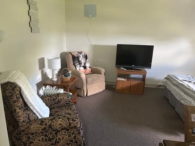 Cozy living area with chairs and TV