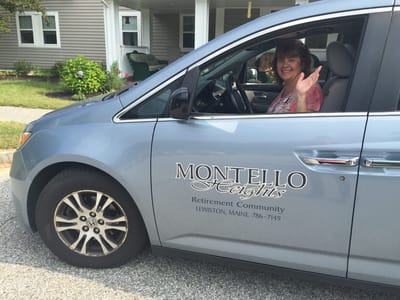A staff member driving a facility transport vehicle